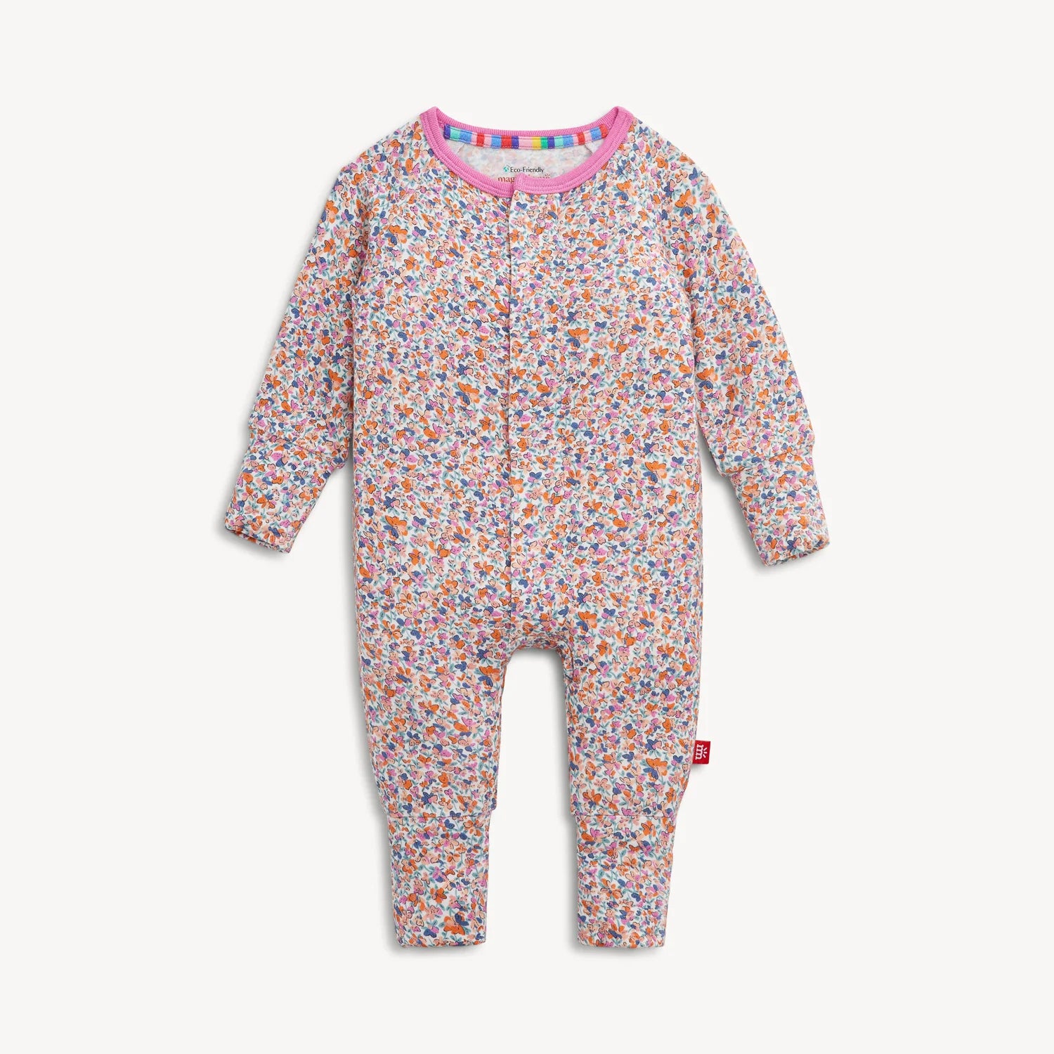 Magnetic Me "Stella" Magnetic Convertible Coverall by Magnetic Me, featuring a floral pattern with long sleeves and legs, a pink collar, convenient front zipper closure, and a red logo tag on the left leg. The garment is displayed flat against a white background.