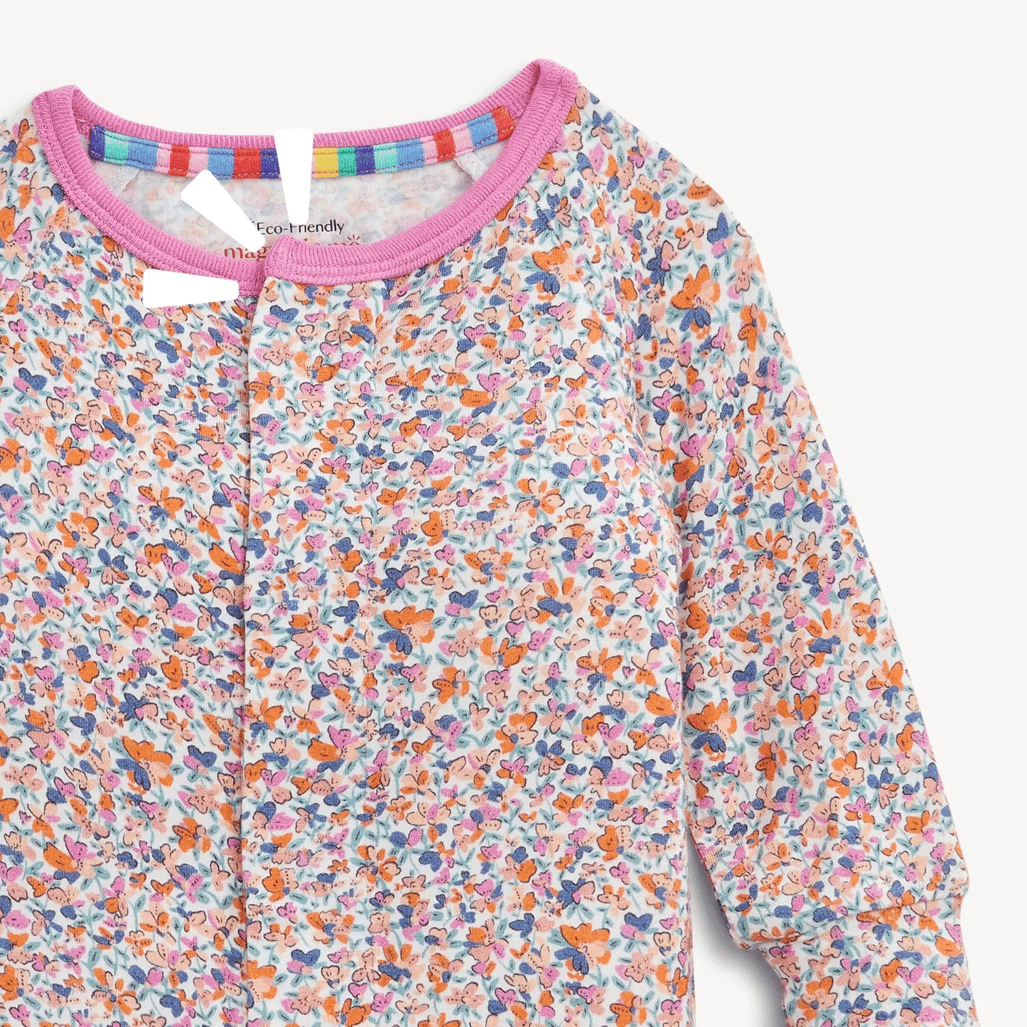 The Magnetic Me "Stella" Magnetic Convertible Coverall by Magnetic Me features a colorful floral and butterfly print, pink trim at the neck, and rainbow stripes lining the collar.