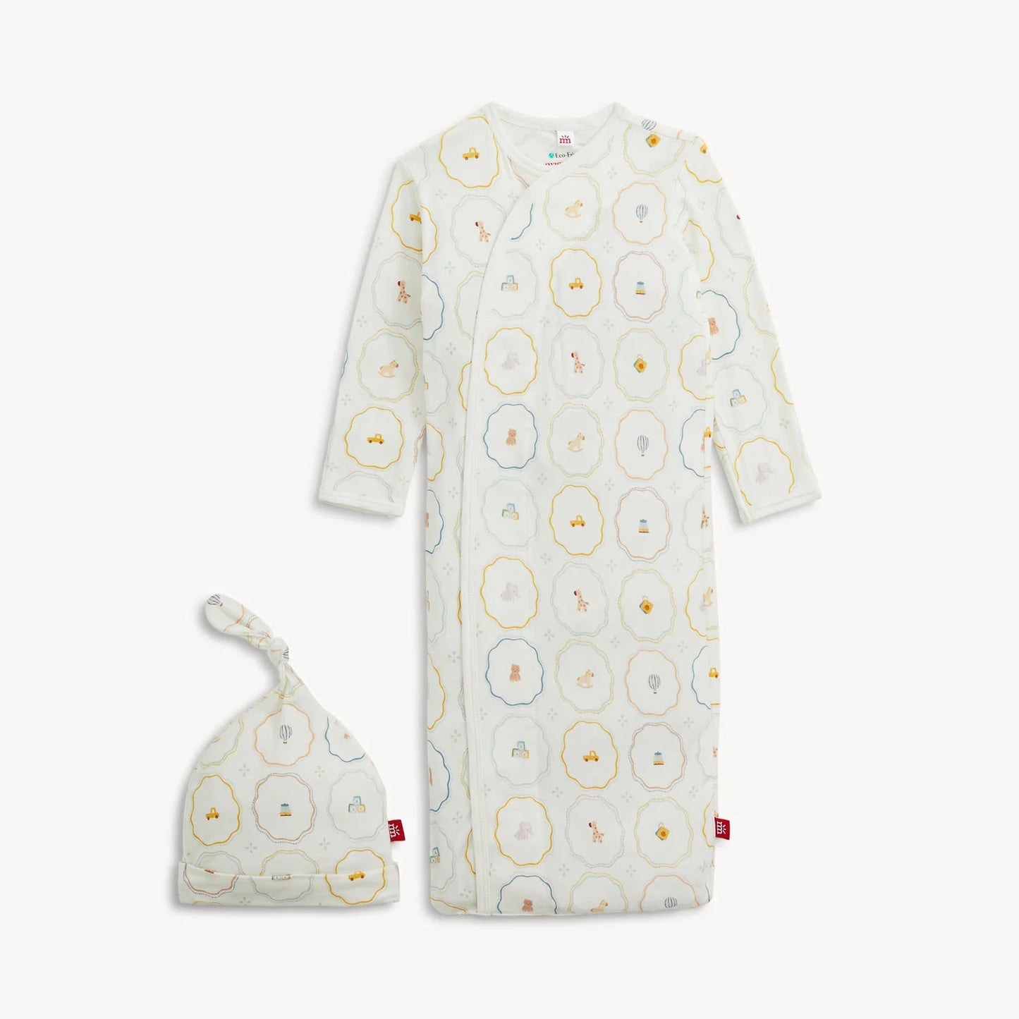The Magnetic Me Nursery Magic Magnetic Gown & Hat Set by Magnetic Me features a soft TENCEL™ modal gown with long sleeves and a matching knotted hat, both adorned with playful animal and geometric prints in pastel shades. The gown is designed with handy magnetic closures for effortless dressing.