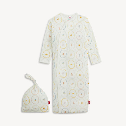 The Magnetic Me Nursery Magic Magnetic Gown & Hat Set by Magnetic Me features a soft TENCEL™ modal gown with long sleeves and a matching knotted hat, both adorned with playful animal and geometric prints in pastel shades. The gown is designed with handy magnetic closures for effortless dressing.