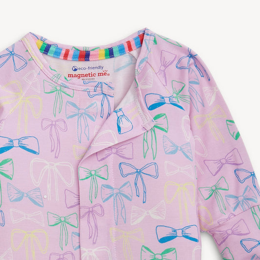 Magnetic Me Take A Bow Modal Convertible Coverall in pink with colorful bow print and rainbow stripe neckline, close-up of chest and shoulders