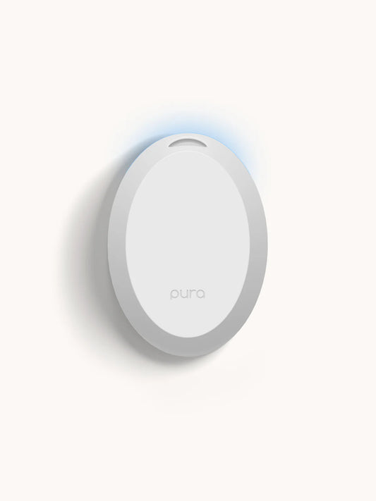 Pura Mini Smart Fragrance Diffuser white oval device with blue light indicator