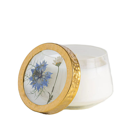 Rosy Rings Accent Pressed Floral Candle Sea Salt Mist with blue flower under gold metal lid on glass vessel