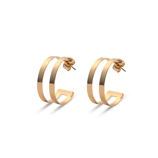 The Leslie Curtis Posey Earrings by Leslie Curtis are a pair of gold-tone geometric hoop earrings featuring a double bar design and secure stud post, shown against a white background. These striking 1.5 inch earrings bring modern elegance to any ensemble.
