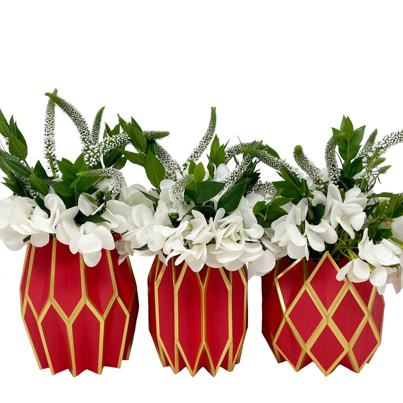 Three Vase Wraps by Lucy Grymes (red & gold) from Lucy Grymes hold arrangements of white flowers and green leaves, displayed against a white background.