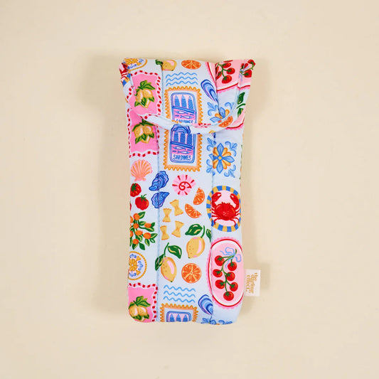 The Darling Effect Puffy Sunglasses Case with multicolored patchwork print featuring citrus, flowers, crabs, and postal stamps on white background