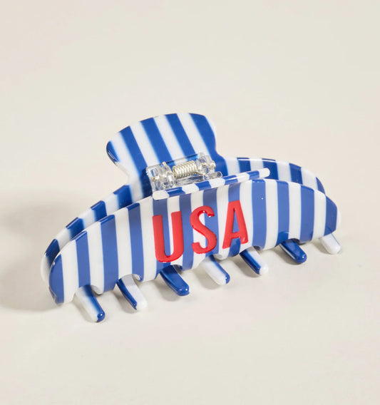The Darling Effect Claw Clip in blue and white vertical stripes with red USA text