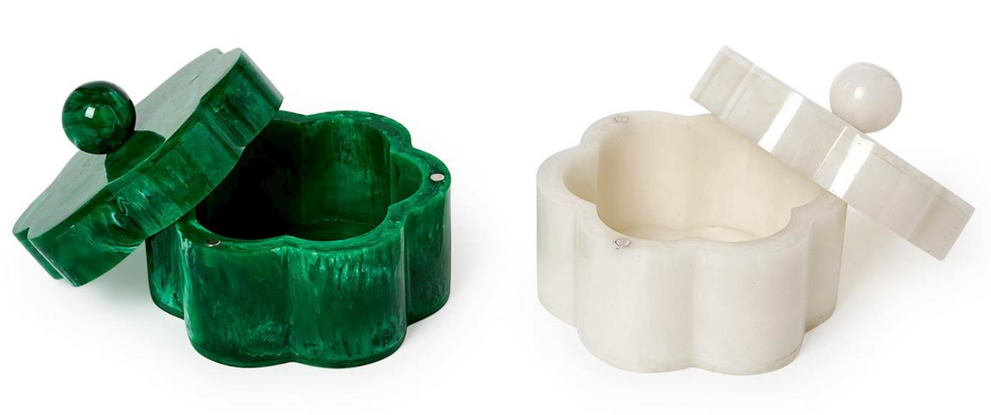 Here’s a rewritten sentence using the provided product data: The Two's Company Marbleized Resin Covered Box set features two small, flower-shaped containers with lids and round knobs—one in green with a matching lid, the other in white. Both lids are slightly open to reveal empty interiors, making these charming decorative storage pieces for a shelf or dresser by Two's Company.