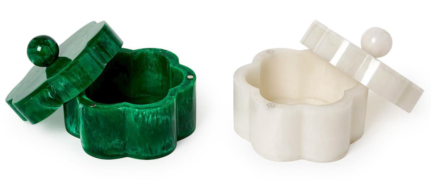 Here’s a rewritten sentence using the provided product data: The Two's Company Marbleized Resin Covered Box set features two small, flower-shaped containers with lids and round knobs—one in green with a matching lid, the other in white. Both lids are slightly open to reveal empty interiors, making these charming decorative storage pieces for a shelf or dresser by Two's Company.
