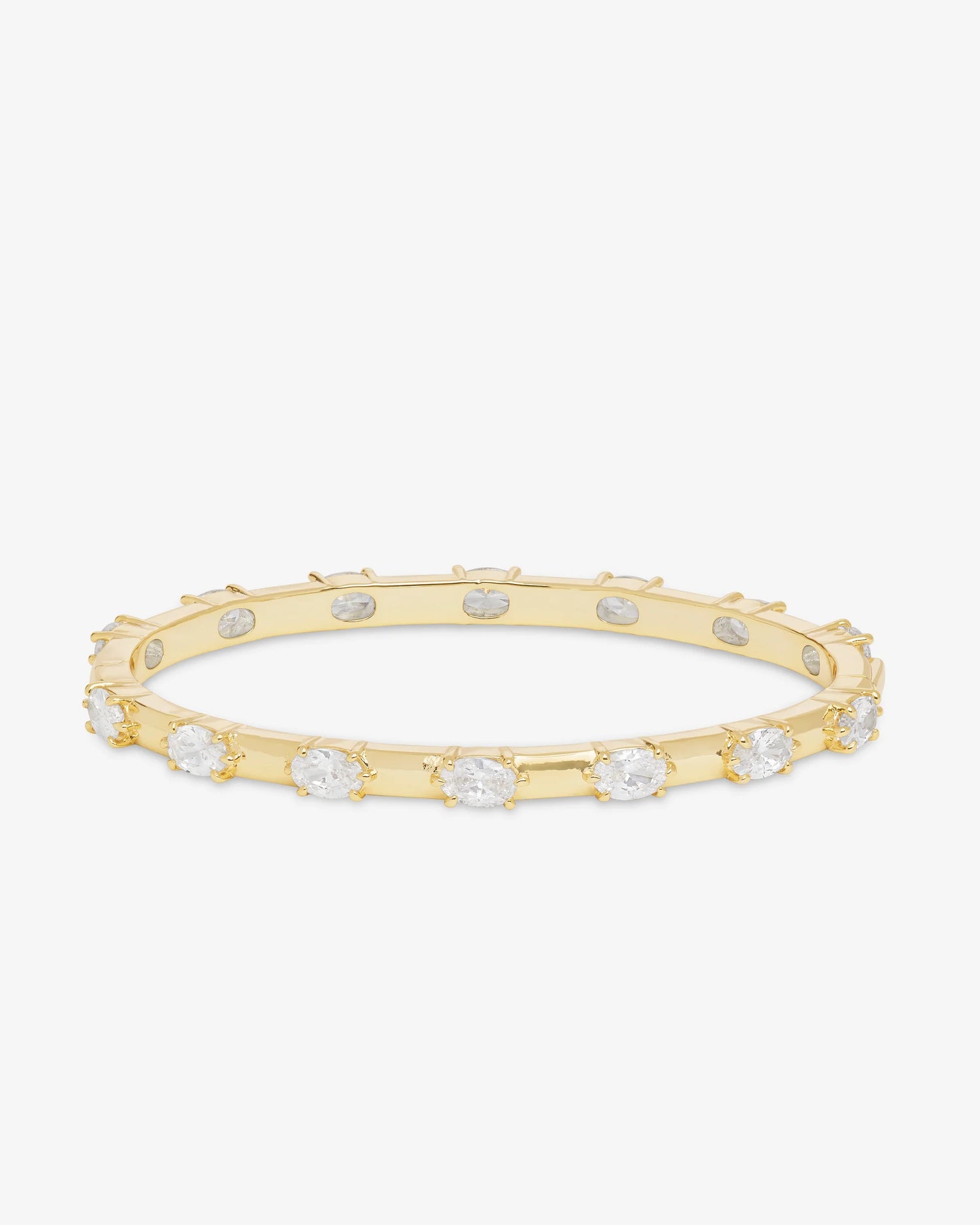 The Melinda Maria She's On Point Station Cuff by Melinda Maria is a gold-plated bangle bracelet adorned with evenly spaced round white gemstones, exuding the timeless elegance of a classic simulated diamond design, and is showcased against a plain white background.