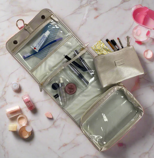 PurseN Toiletry Case in pearl opened to show clear compartments holding makeup brushes, skincare products, and accessories
