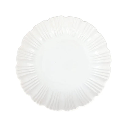 A white, round Vietri Bari White Shallow Serving Bowl with a scalloped, textured edge, viewed from above on a plain background. This Vietri serving bowl is microwave and dishwasher safe, combining elegance with everyday convenience.
