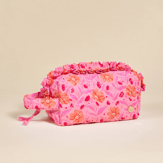 The Darling Effect Essentials Quilted Cosmetic Bag in pink with orange floral pattern and ruffled edge
