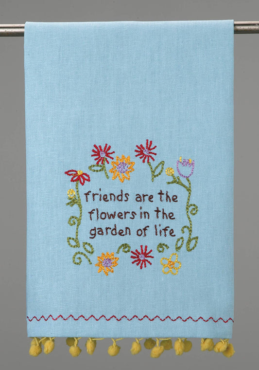 Light blue Peking Handicraft kitchen towel with colorful embroidered flowers and 'friends are the flowers in the garden of life' text, yellow pom-pom
