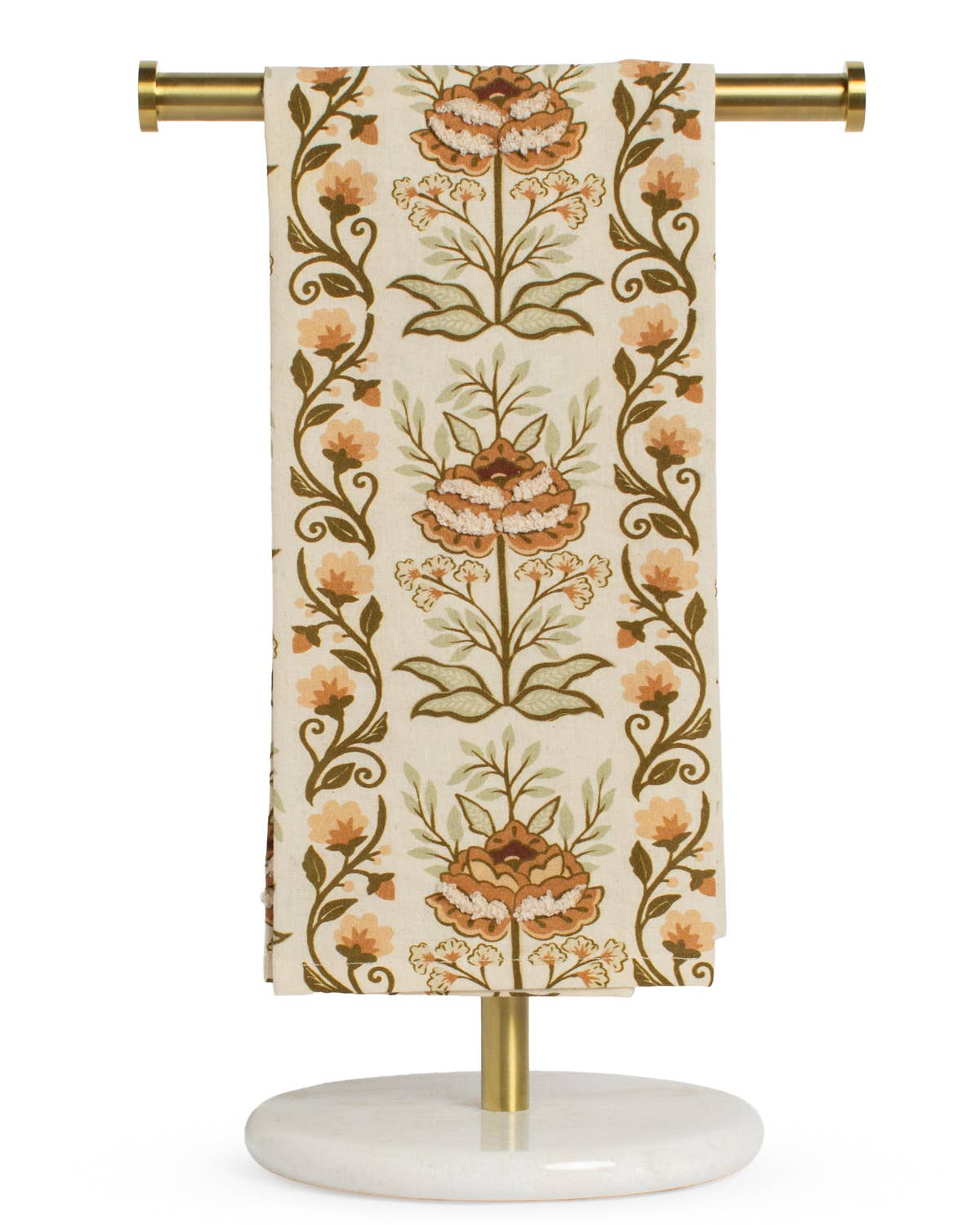 A brown and orange floral-patterned fabric is elegantly draped over a gold and marble stand against a white background, highlighting The Royal Standard’s Adeline Hand Towel as both a luxurious, soft essential and a stylish decorative accent.