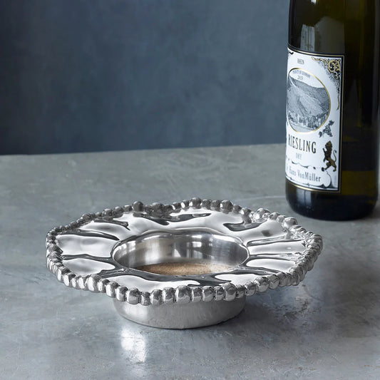 Beatriz Ball Organic Pearl Wine Coaster in polished silver with beaded edge rim, styled with wine bottle