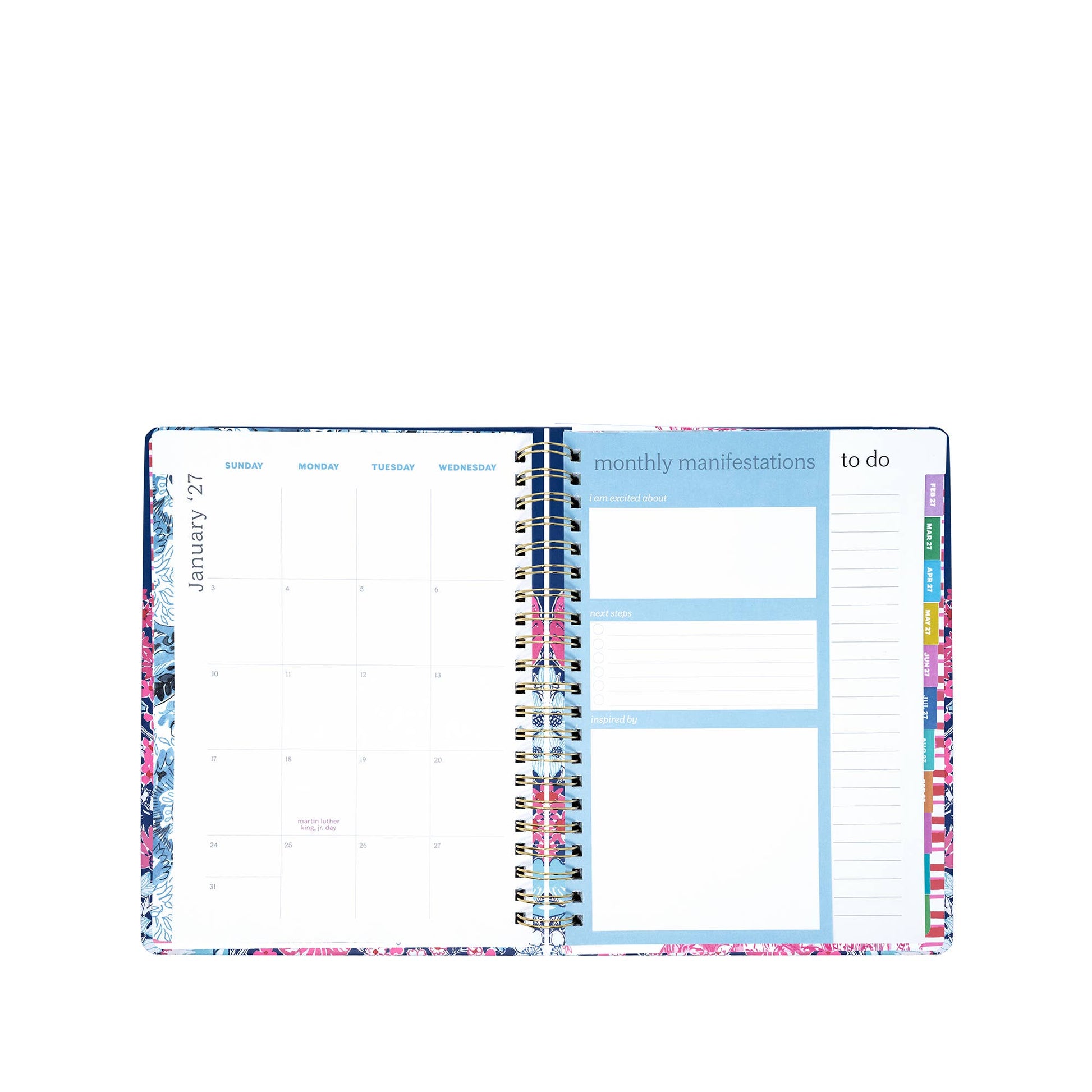 An open Lilly Pulitzer by Lifeguard Press - Jumbo 17 Month Agenda, In All Her Glory is displayed, featuring a monthly calendar on the left and sections for monthly manifestations and a to-do list on the right, all highlighted with colorful edges.
