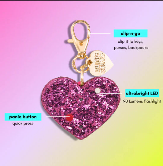 Bling Sting hot pink glitter heart alarm features annotated with clip, LED light, panic button