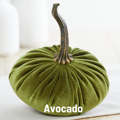 A plush green velvet pumpkin from Your Heart’s Content, featuring a brown stem, rests on a light surface. Ideal for a Valentine’s mantel or autumn table décor, the product name “Your Heart’s Content - Pumpkin Small Velvet” is displayed in bold white letters at the bottom.