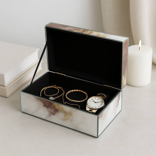 Sagebrook Home Decorative Box with watercolor marble pattern, open lid revealing black interior holding gold bracelets and watch