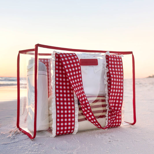 Case-Mate Cherry Gingham Jelly Tote with red-and-white gingham handles and clear jelly panels on beach