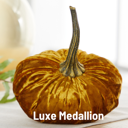 A plush, golden velvet pumpkin from Your Heart’s Content sits on a light surface, making it the perfect centerpiece for Thanksgiving or your Valentine’s mantel. The words “Your Heart’s Content - Pumpkin Small Velvet” are written in bold white letters at the bottom.
