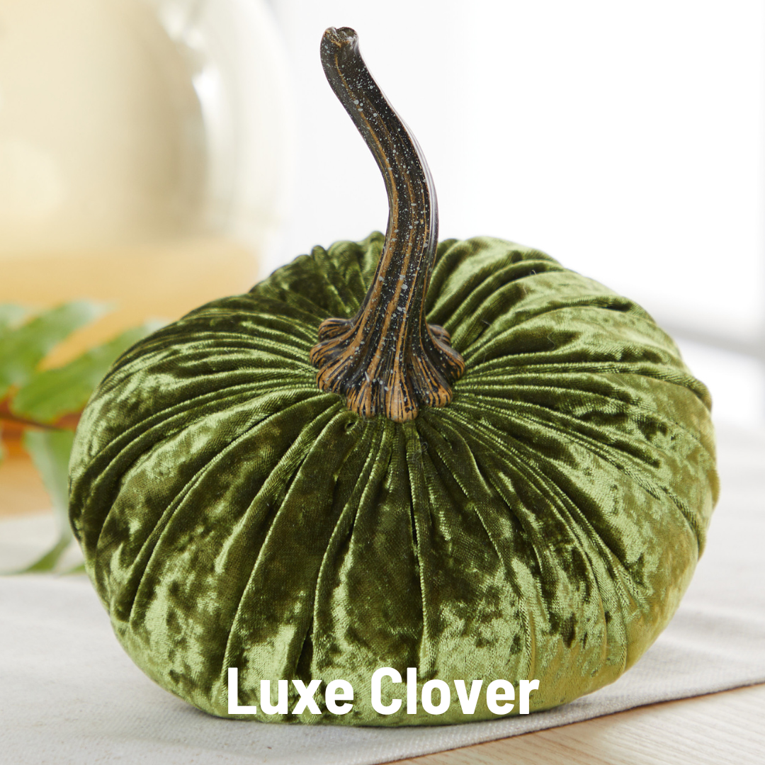 A small velvet pumpkin by Your Heart’s Content, in deep green with a brown stem, sits elegantly on a table—perfect as a Thanksgiving centerpiece, for your Valentine’s mantel, or as a thoughtful autumn gift. The words “Your Heart’s Content” appear at the bottom of the image.