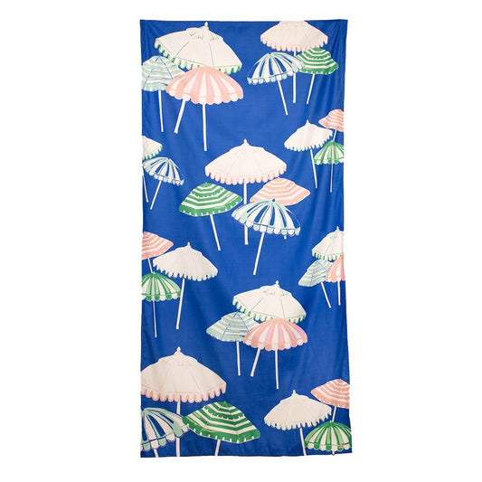 The Royal Standard Monterosso Beach Towel in sapphire blue with colorful beach umbrella pattern in pink, white, and green