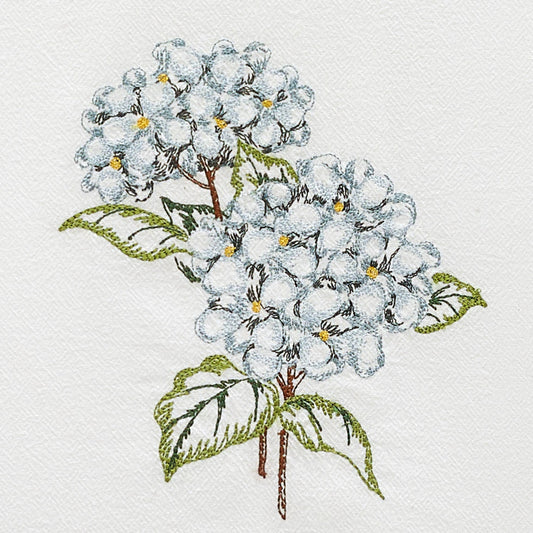 Close-up detail of Peking Handicraft Hydrangea Kitchen Towel showing embroidered blue flower cluster with yellow centers