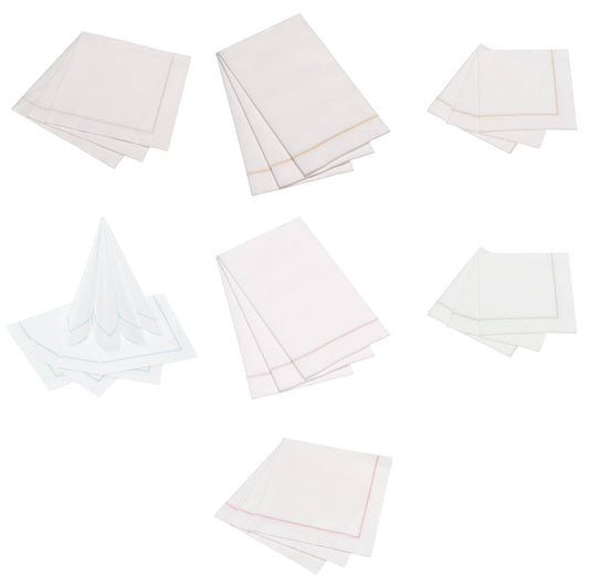 The Napkins 25ct Hemstitch guest napkins in white with tan borders, multiple stacked arrangements