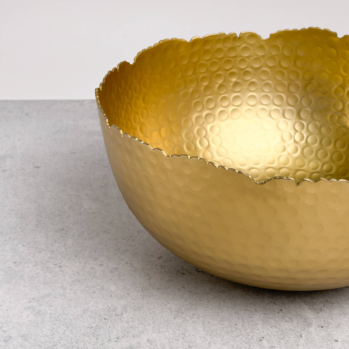 India Handicrafts Inc Large Gilded Hammered Bowl side detail of hammered circular pattern and wavy edge