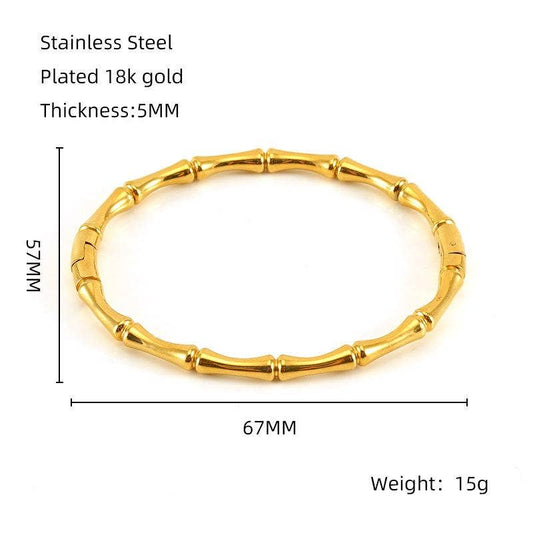 Introducing the Mio Queena - Multi-style 18K Gold-plated Stainless Steel Bangle (FGS), a bamboo-inspired bracelet from Mio Queena. Expertly crafted from durable stainless steel and finished with lustrous 18K gold plating, this bangle features a 67mm inner diameter, 75mm outer diameter, and a sleek 5mm thickness, weighing just 15g. Ideal as an elegant jewelry gift, it is beautifully showcased on a white background with product name, text, and measurements displayed beside the bracelet.