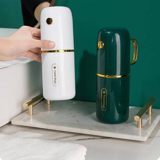 VIGOR luxury travel toothbrush holders in white and forest green with gold accents on marble base, one held in hand