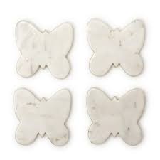 Four Two's Company white marble butterfly-shaped coasters arranged in grid