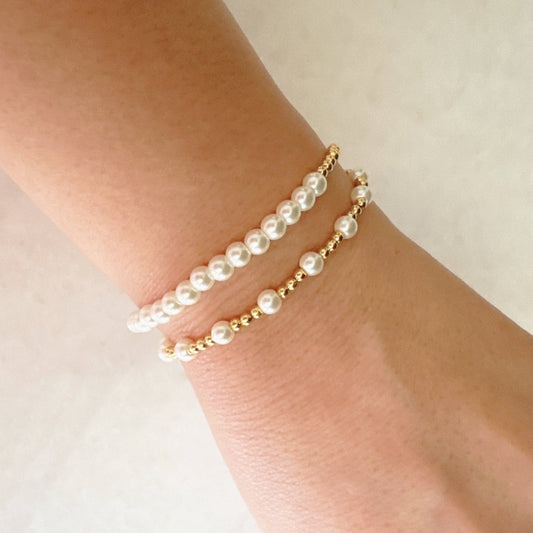 Ellison+Young Pearls and Gold Stretch Bracelet Set worn on wrist, showing pearl and gold bead designs