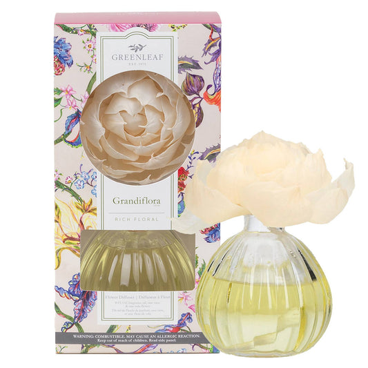 Greenleaf Grandiflora diffuser with cream flower topper, pale yellow-green liquid, and colorful floral-patterned box