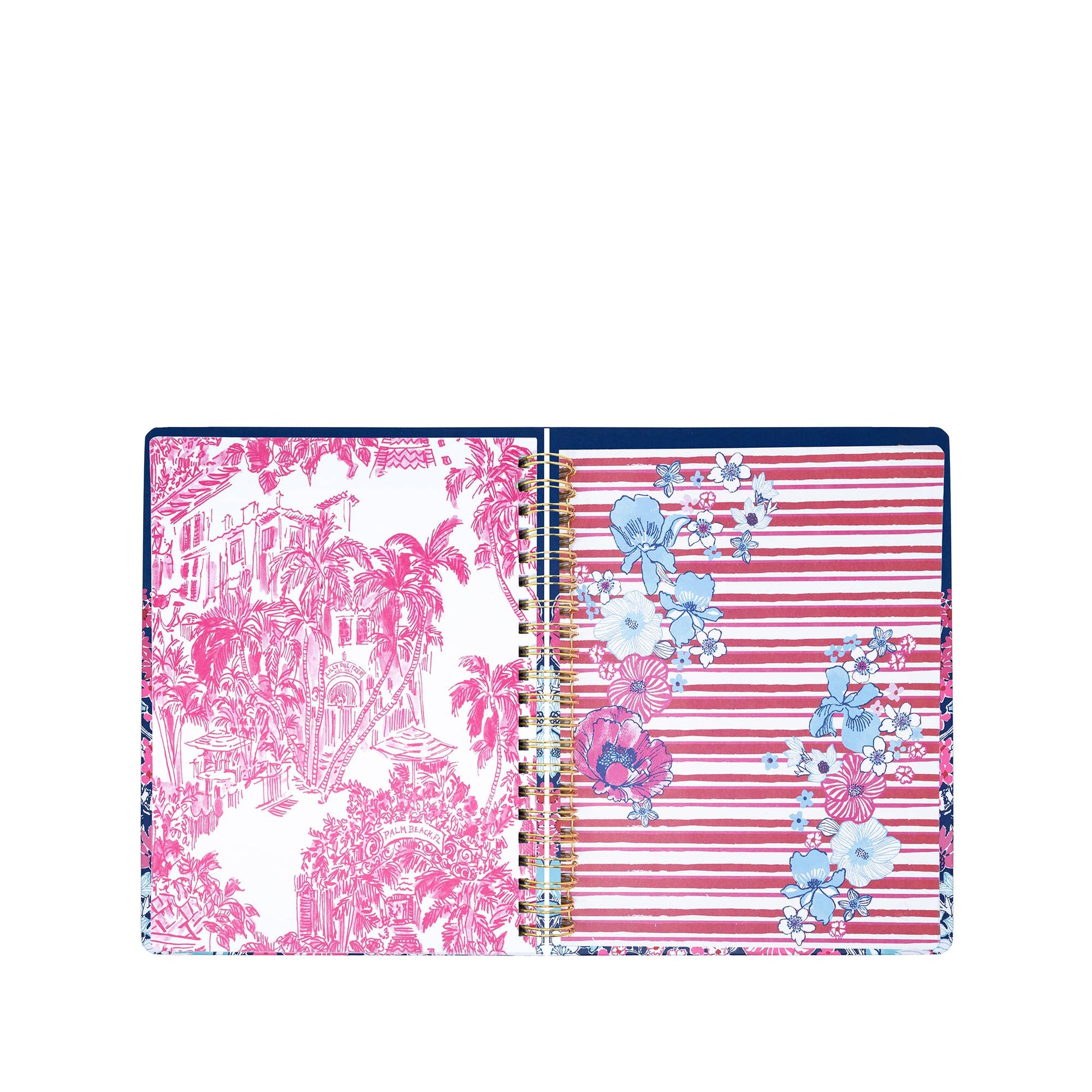 The Lilly Pulitzer by Lifeguard Press - Jumbo 17 Month Agenda, In All Her Glory, is an open spiral-bound planner displaying a page with pink tropical landscape art and another featuring pink stripes accented with blue, white, and pink floral designs.