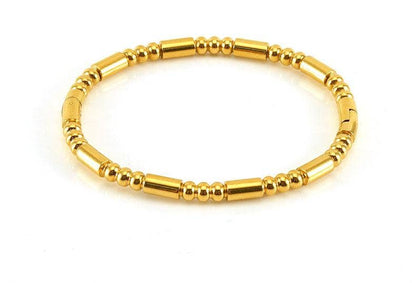 Introducing the Mio Queena - Multi-style 18K Gold-plated Stainless Steel Bangle - FGS by Mio Queena, featuring alternating small round and cylindrical beads arranged in a simple, elegant circular design. Displayed on a white background, this stylish piece is an ideal choice for jewelry gifts.