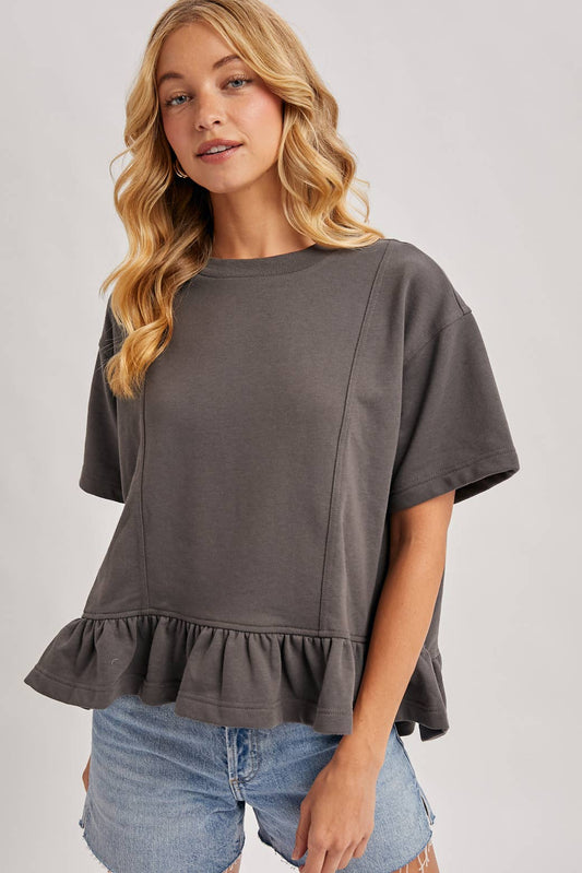 Bluivy Ruffled Peplum Hem Boxy Swing Knit Tee in charcoal, front view with denim shorts