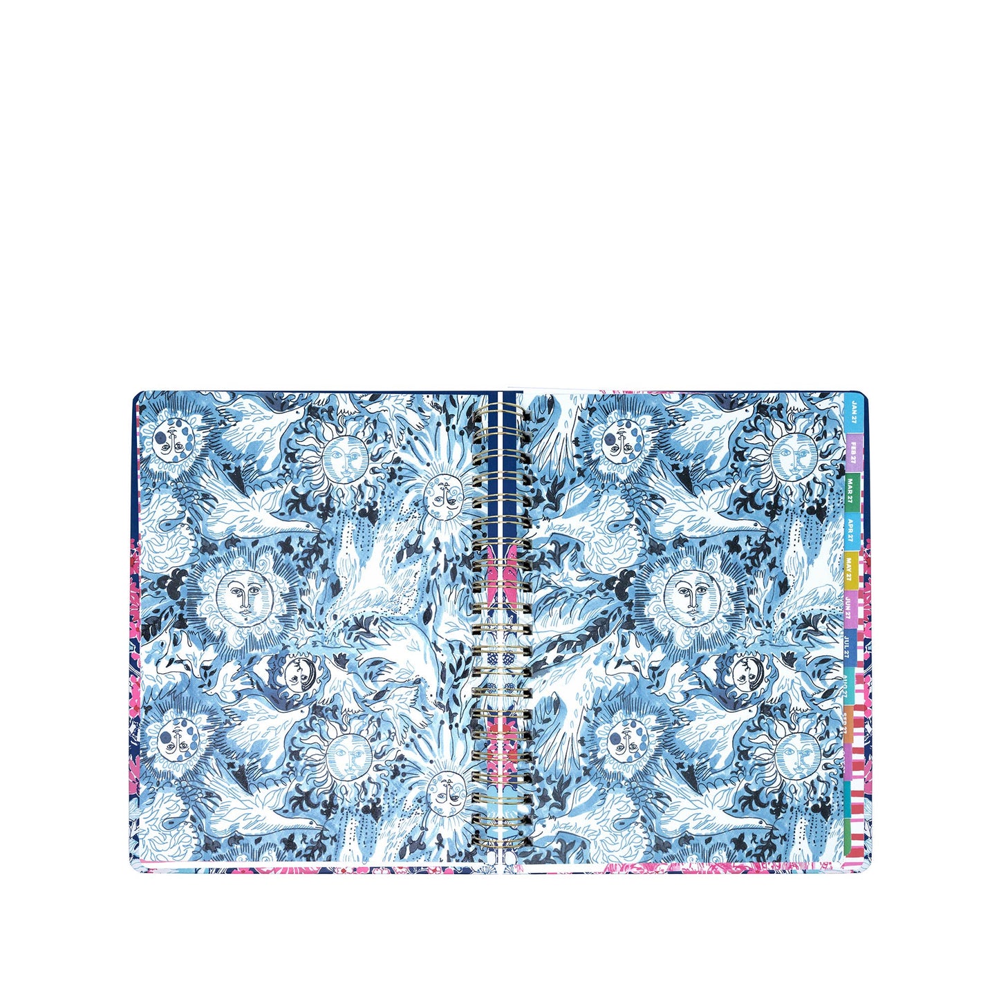 A Lilly Pulitzer by Lifeguard Press Jumbo 17 Month Agenda, In All Her Glory, lies open to reveal blue and white pages adorned with intricate sun and moon designs, while colored tab dividers from the planner are visible along the right edge.