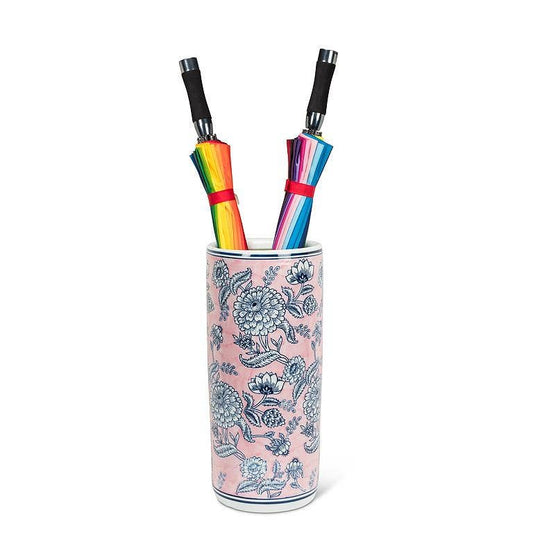 Abbott Floral Print Umbrella Stand holding rainbow and gradient umbrellas with blue floral design on pink