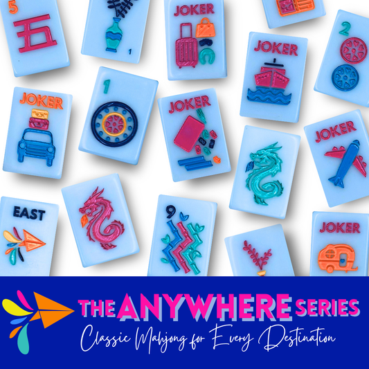 My Fair Mahjong Anywhere Series tiles scattered on white background, light blue tiles with magenta and teal travel-themed designs including jokers,