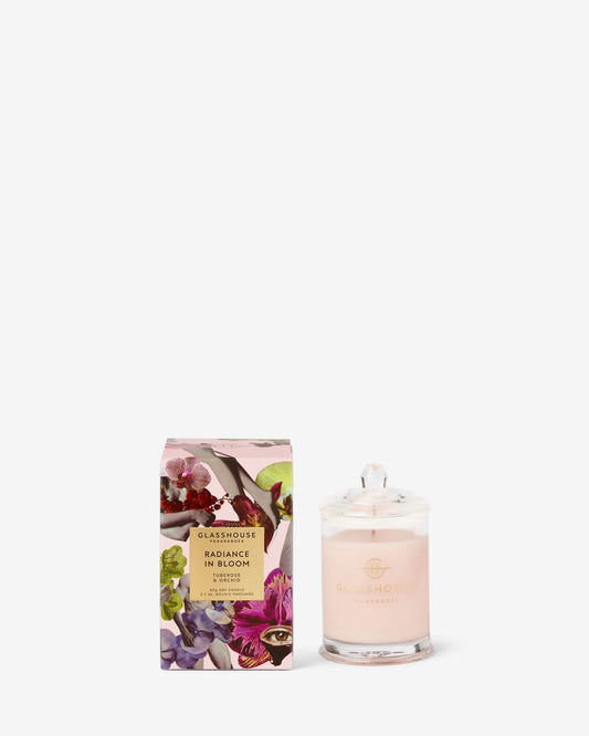 Glasshouse Radiance in Bloom 2.1oz soy candle in pale pink glass with matching floral box featuring orchids and botanical motifs