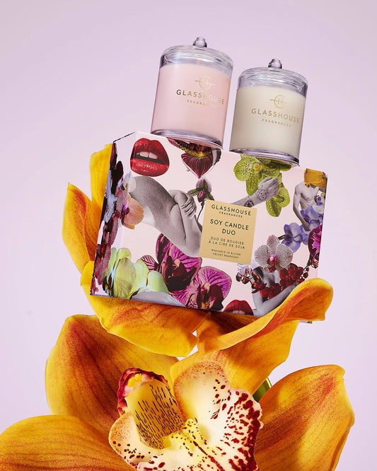Glasshouse Mother's Day Soy Candle Duo with two pink and cream glass jars displayed on colorful floral packaging with large orchid petals