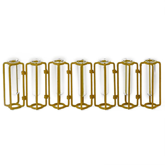Seven Tozai Home hinged brass-tone flower vases arranged in a row, closed position