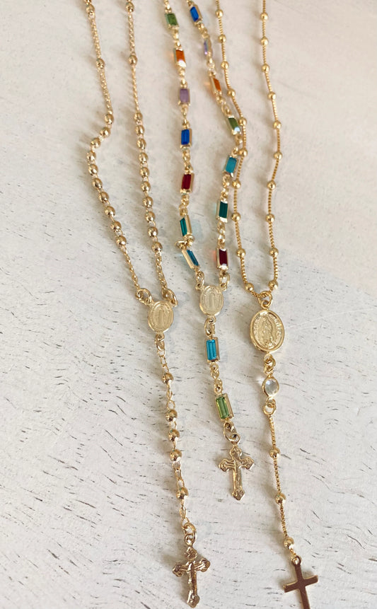 Coastal Grit Vigilant Rosary necklaces in gold with colorful crystal beads and cross pendants, displayed on white background