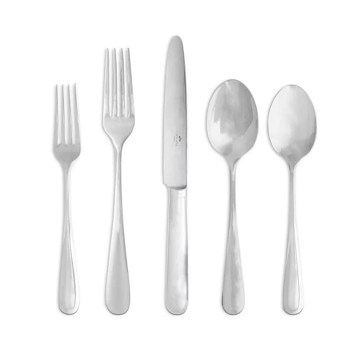 Five pieces from the Costa Nova "Lumi" Stainless Flatware collection by Costa Nova are shown: a salad fork, dinner fork, knife, soup spoon, and teaspoon. Each piece is crafted from shiny stainless steel and arranged in a row on a white background.