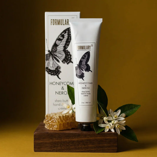 Formulary 55 Honeycomb & Neroli Shea Butter Hand & Body Cream 3oz with box, displayed with honeycomb and white flowers