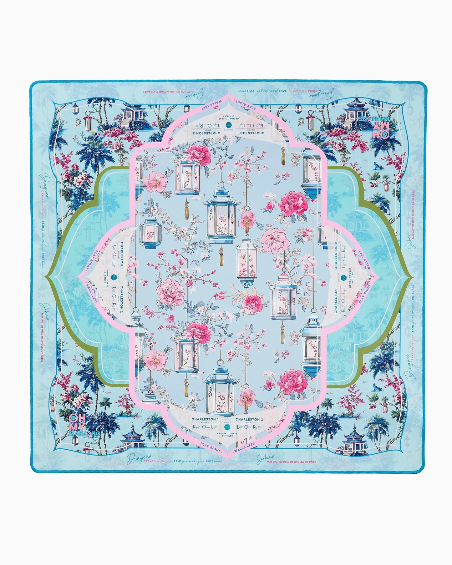 Introducing the Oh My Mahjong Radiance Mat in Tube by Holmes Stationers and Gifts—a decorative silk mat featuring a floral and lantern motif, bordered in blue, green, and pink. Inspired by chinoiserie mahjong mats, its elegant background showcases palm trees, graceful architecture, and flowing cursive script for an exquisite finish.