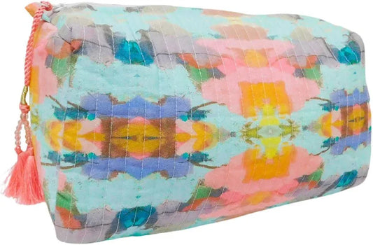 Laura Park quilted cosmetic bag in light blue with pink and yellow geometric design, angled side view